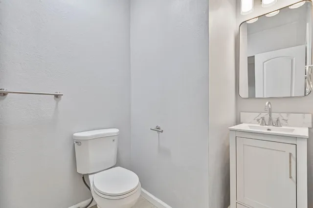 a white toilet sitting next to a bathroom sink
