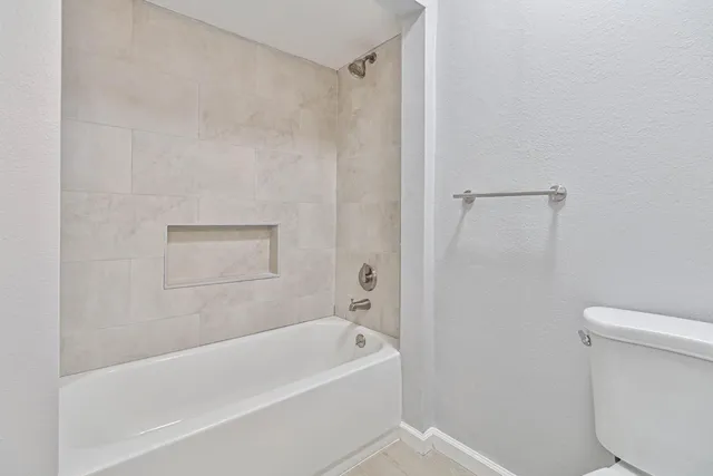 a bathroom with a bathtub and a toilet