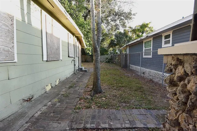 a backyard of a house with table and chairs