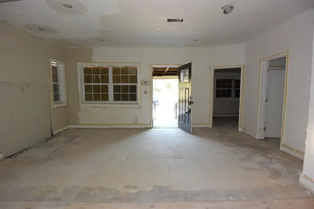 an empty room with a empty space and windows