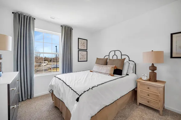 a bedroom with a bed and a large mirror