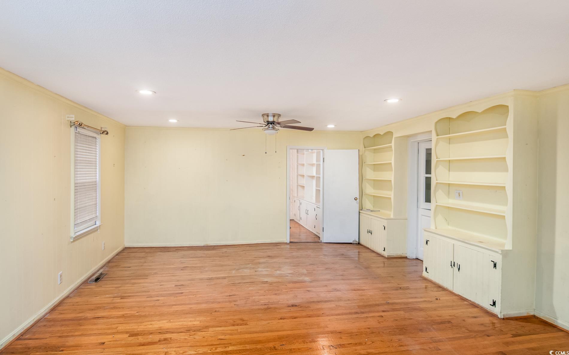 1010 Highmarket Street Georgetown, SC 29440 - Photo 11 of 32 Unfurnished room with light wood-type flooring, built in features, recessed lighting, and ceiling fan