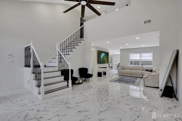 a living room with furniture and stairs