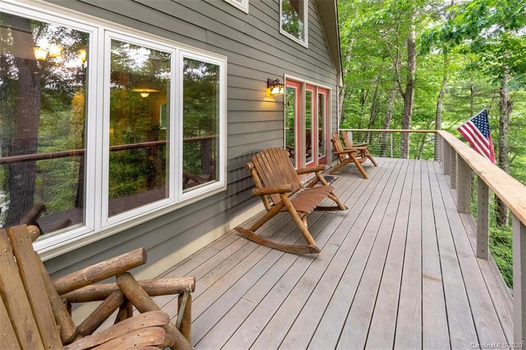 136 Dars Lane Tuckasegee, NC 28783 - Photo 12 of 48 a balcony with wooden floor table and chairs