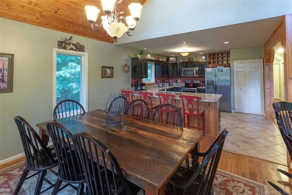 136 Dars Lane Tuckasegee, NC 28783 - Photo 13 of 48 a view of a dining room with furniture window and wooden floor