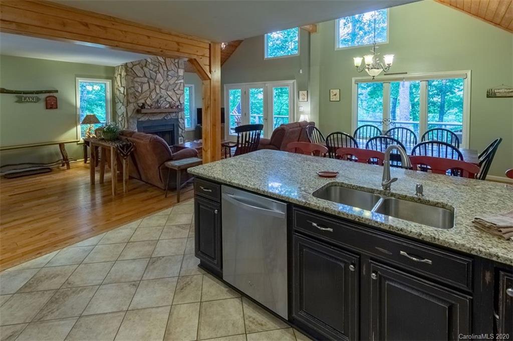 136 Dars Lane Tuckasegee, NC 28783 - Photo 16 of 48 a kitchen with stainless steel appliances granite countertop a sink a counter space and cabinets