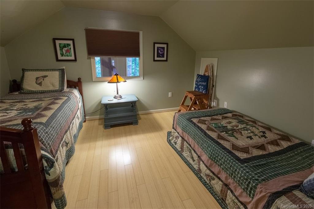 136 Dars Lane Tuckasegee, NC 28783 - Photo 20 of 48 a bedroom with bed and window