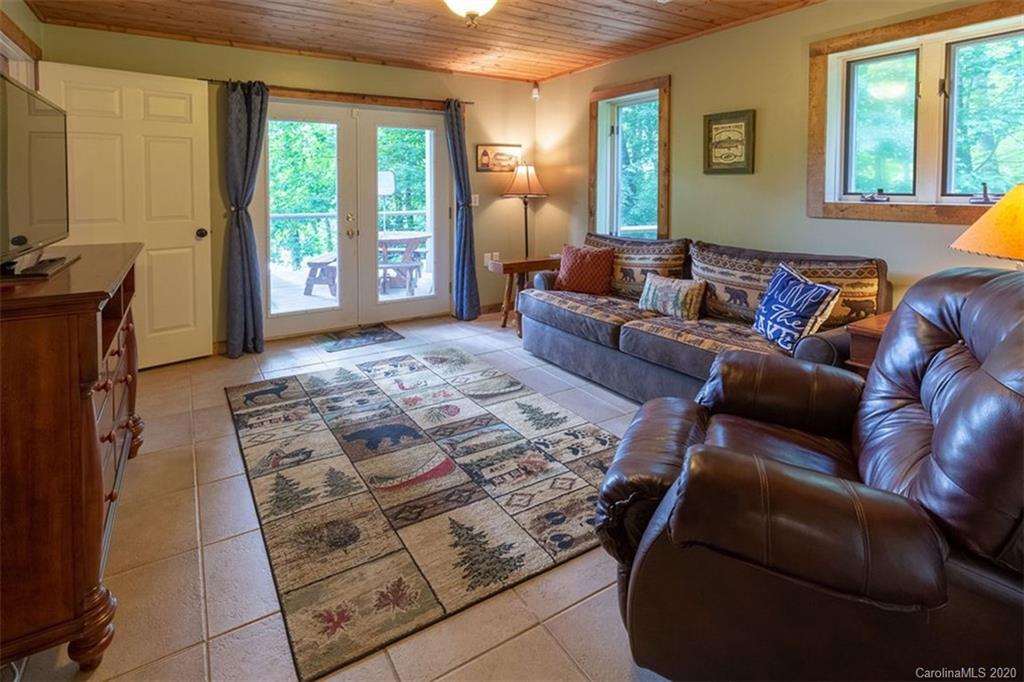 136 Dars Lane Tuckasegee, NC 28783 - Photo 26 of 48 a living room with furniture and a flat screen tv