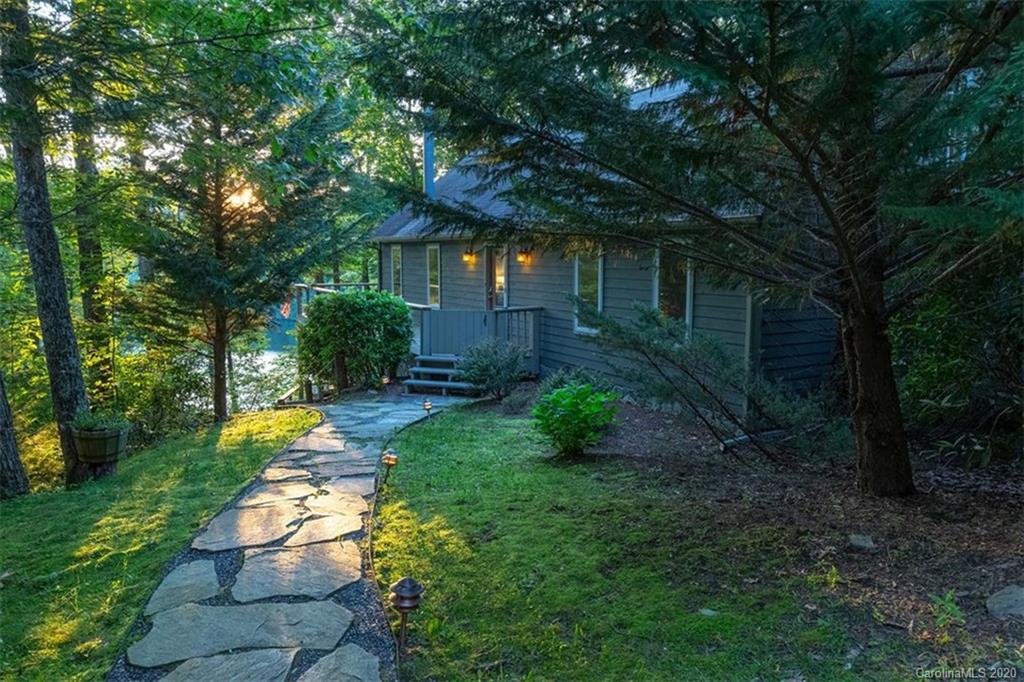 136 Dars Lane Tuckasegee, NC 28783 - Photo 4 of 48 a view of a yard with plants and large trees