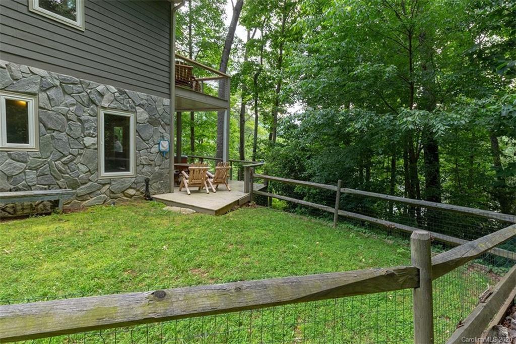 136 Dars Lane Tuckasegee, NC 28783 - Photo 37 of 48 a view of a chair and tables in the backyard