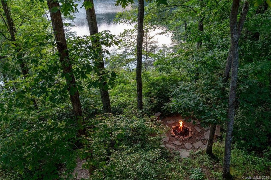 136 Dars Lane Tuckasegee, NC 28783 - Photo 38 of 48 a backyard of a house with a yard and outdoor seating