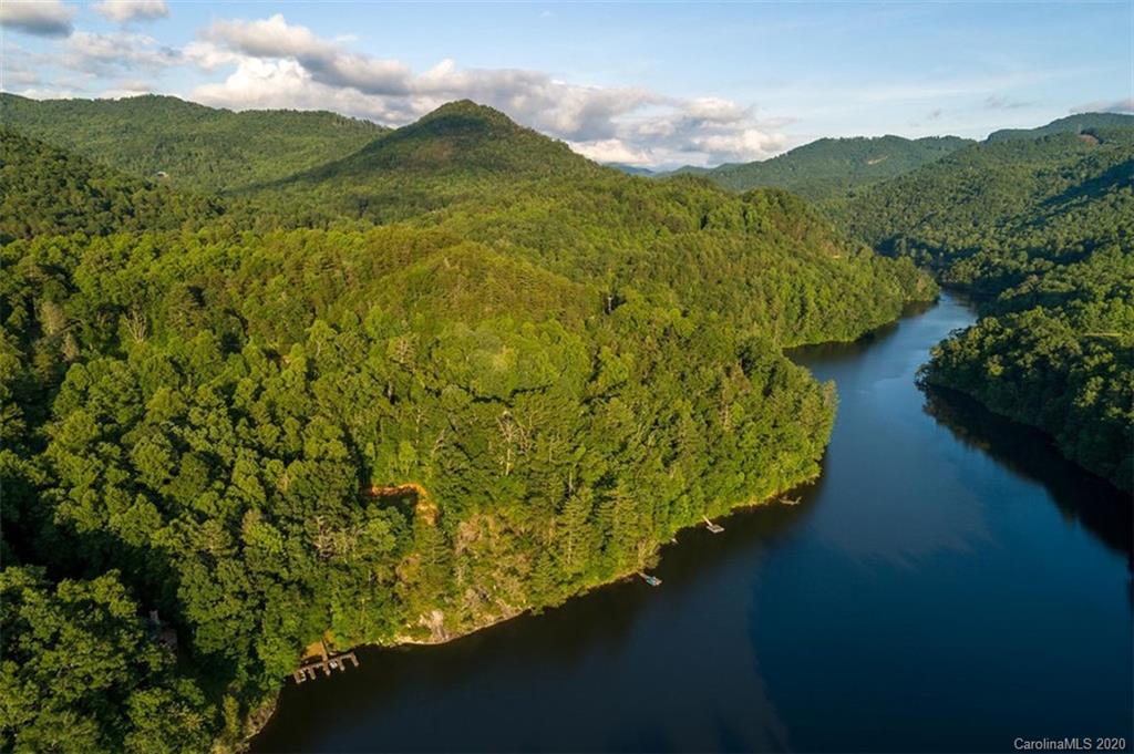 136 Dars Lane Tuckasegee, NC 28783 - Photo 40 of 48 a view of a lake with a mountain in the background
