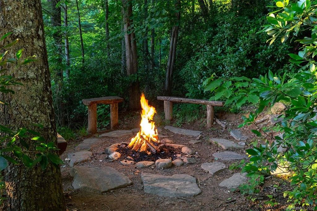 136 Dars Lane Tuckasegee, NC 28783 - Photo 48 of 48 a view of a chairs and fire pit in the forest