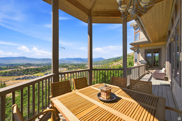 335 Bern Way Midway, UT 84049 - Photo 26 of 88 Spacious covered deck featuring wood-finish flooring, a wood plank ceiling, and a decorative chandelier