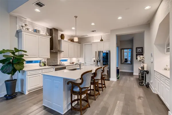 a large kitchen with a table and chairs in it