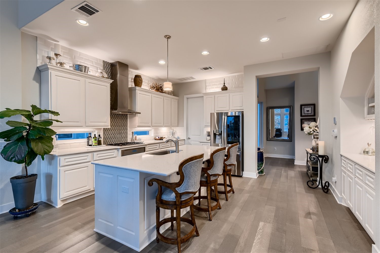 a large kitchen with a table and chairs in it