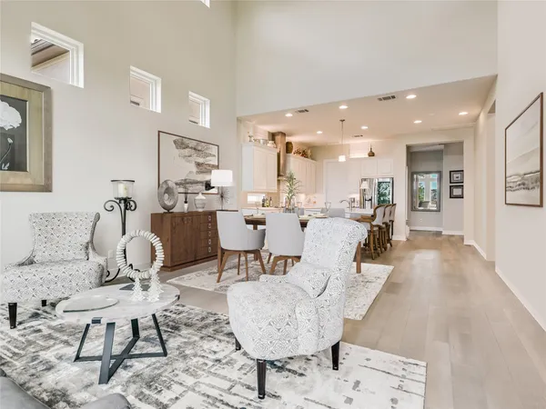 a living room with furniture and a dining table