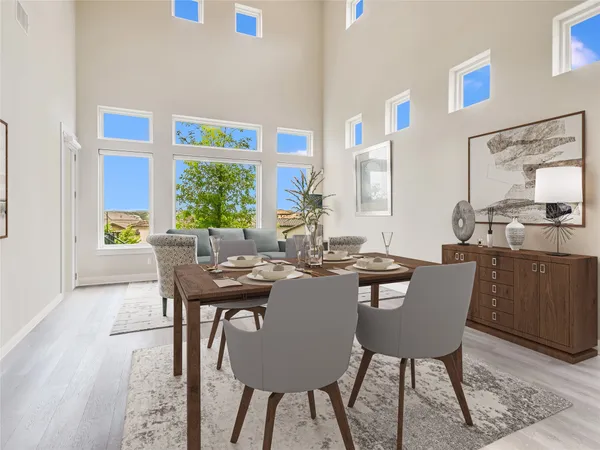 a view of a dining room with furniture and a window