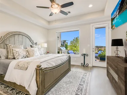 a bedroom with a bed and a flat tv screen on dresser