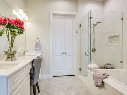 a bathroom with a granite countertop sink a shower and a mirror
