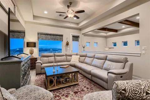 a living room with furniture a rug and a chandelier