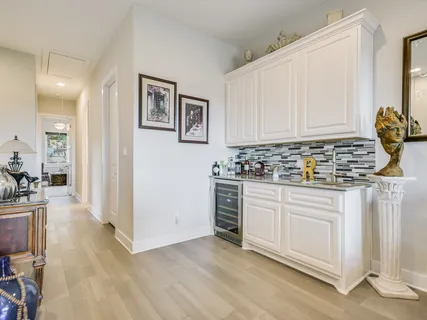 a kitchen with stainless steel appliances granite countertop a stove and white cabinets