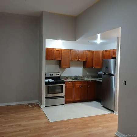a kitchen with stainless steel appliances granite countertop a stove and a refrigerator
