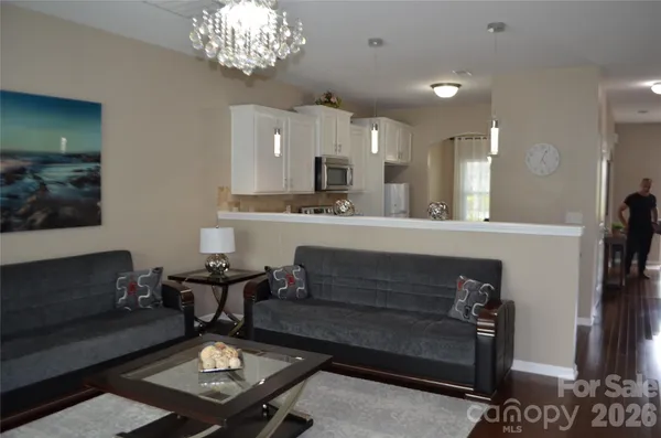 a living room with furniture and a chandelier