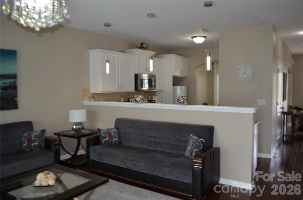 a living room with furniture and a chandelier