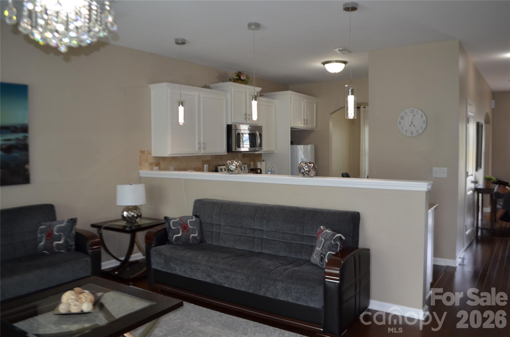 4549 Tradd Circle Monroe, NC 28110 - Photo 12 of 33 a living room with furniture and a chandelier