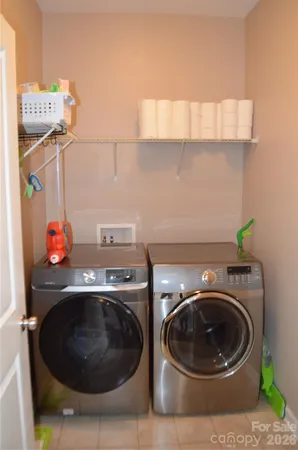 a utility room with sink dryer and washer