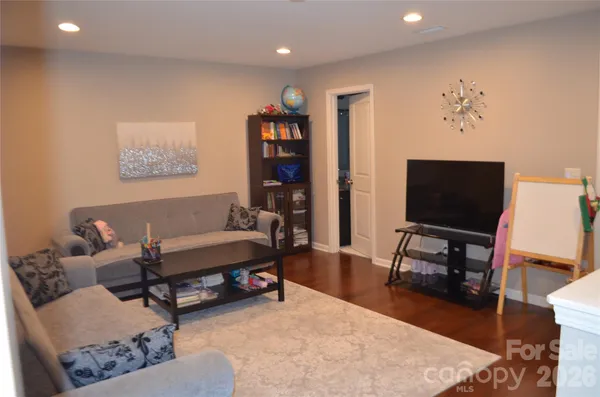 a living room with furniture and wooden floor