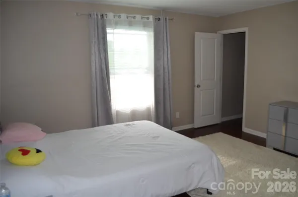 a bedroom with a bed and a mirror