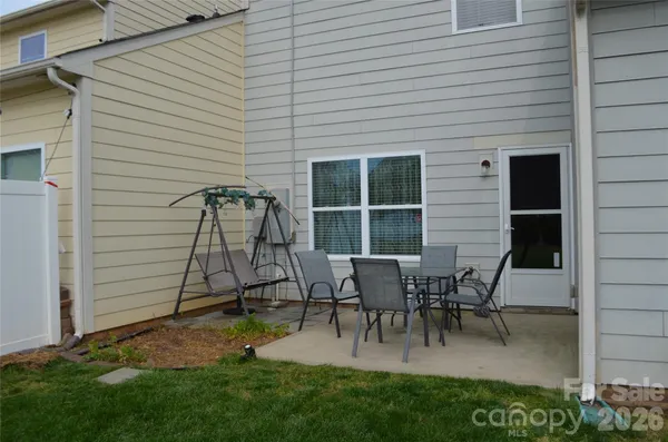 a view of a house with backyard and a sitting area