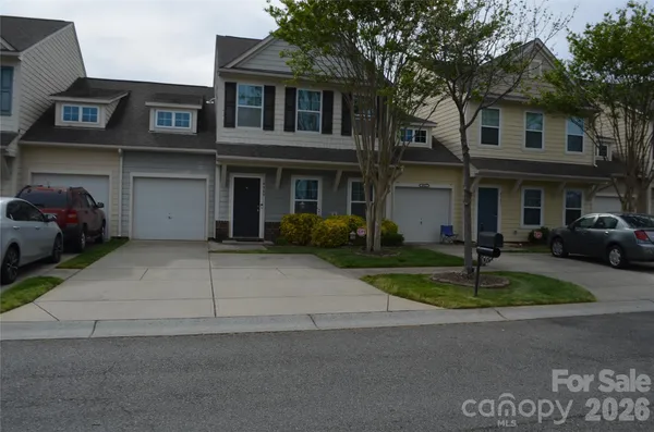 a view of a brick house with a yard