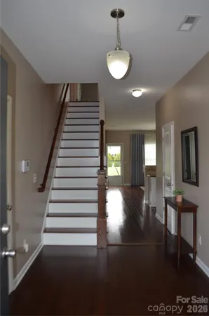 a view of entryway and hall with wooden floor