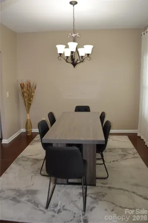 a view of a dining room with furniture wooden floor and chandelier