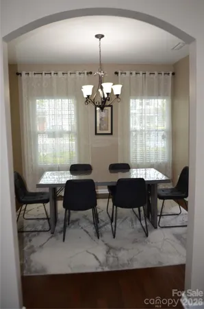 a living room with furniture a window and a chandelier