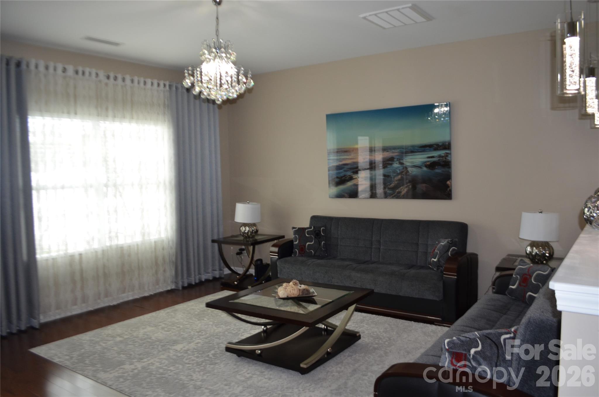 4549 Tradd Circle Monroe, NC 28110 - Photo 10 of 33 a living room with furniture and a chandelier