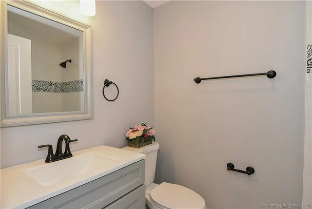 a bathroom with a sink toilet and mirror