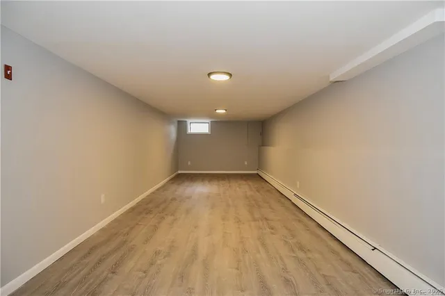 a view of a big room with wooden floor and windows in a room