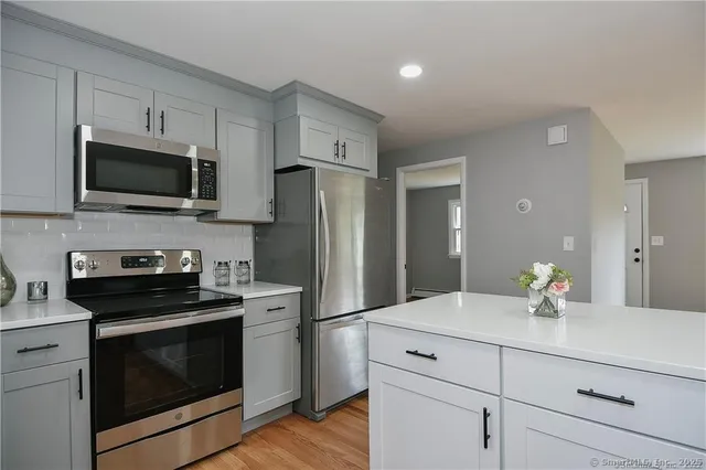 a kitchen with a refrigerator stove and microwave