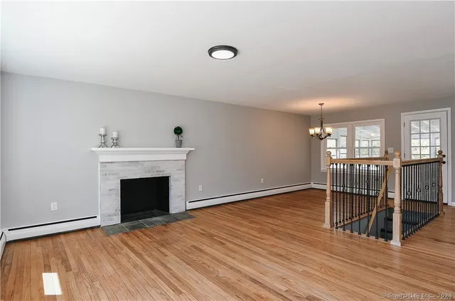 a view of livingroom with wooden floor and fireplace