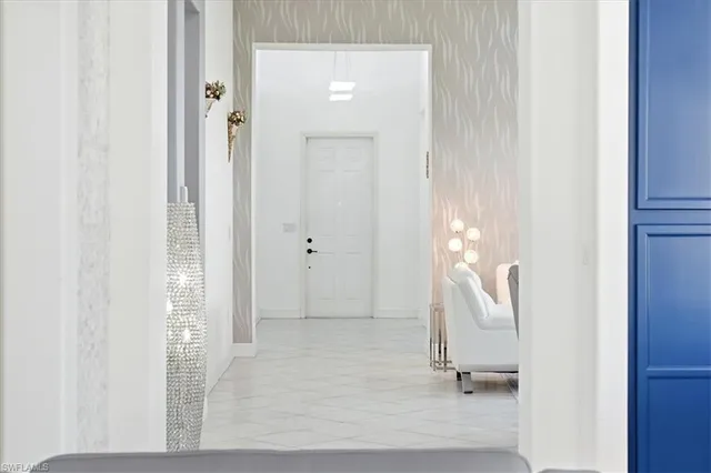 a bedroom with a bed a window and potted plant on the dresser