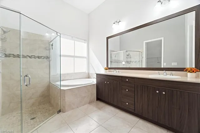 a bathroom with a shower sink and mirror