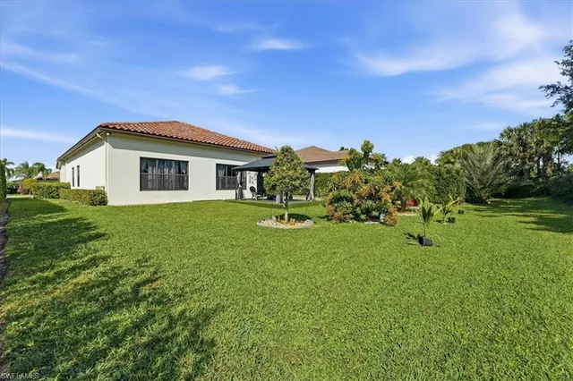 an aerial view of a house with a garden and lake view