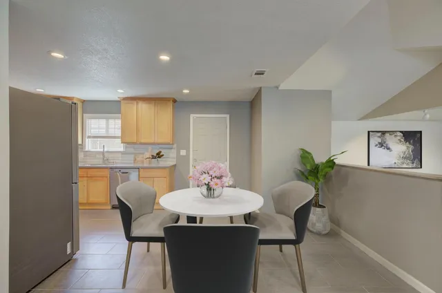 a kitchen with stainless steel appliances granite countertop a refrigerator a stove a sink and a microwave