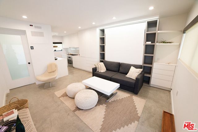 a living room with furniture and kitchen view