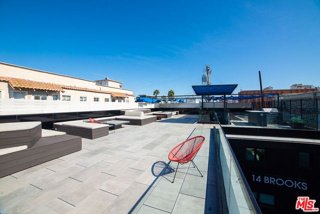 a terrace with outdoor seating and city view