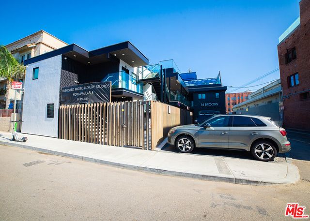 a view of a car parked in front of a house
